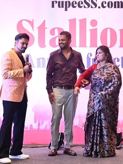 Interacting with senior members of the company on stage. I am comfortable and respectful when engaging with company leadership, ensuring a professional yet warm atmosphere.