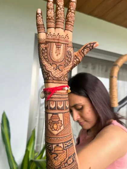 This design for a festival features a kalash (ceremonial pot) on the arm, a symbol of prosperity and celebration.
