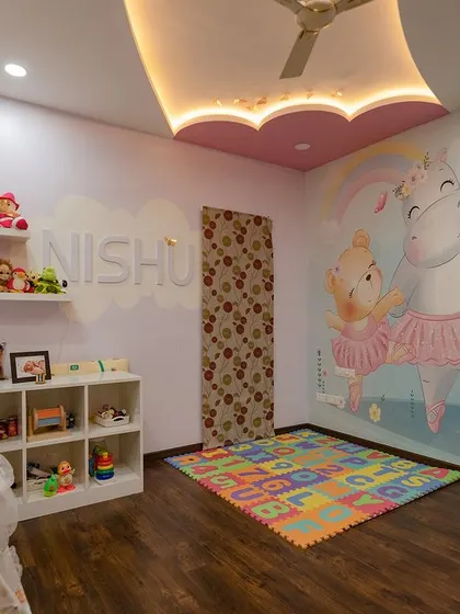 A wider view of the enchanting nursery. The combination of the large wall mural, playful floor mat, and soft lighting creates a perfect space for a growing mind.