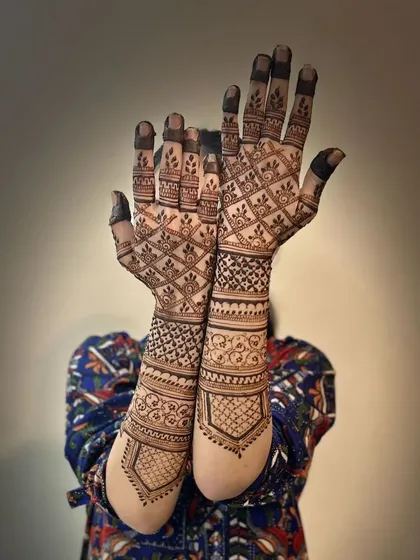 A classic semi-bridal design with geometric check patterns and traditional borders.