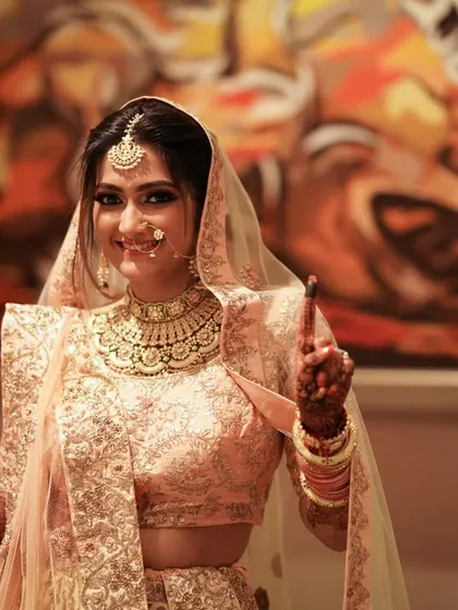 The look of a happy bride, ready to celebrate. Her joyful expression and beautiful attire are a perfect combination.