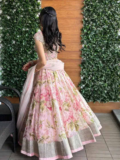 Another view of our beautiful pink floral lehenga, a popular designer-inspired piece available for rent.