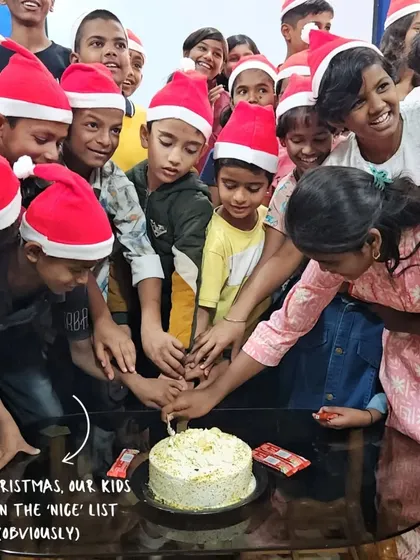 This Christmas, our kids are on the 'nice' list. A group of children gathers to cut a cake, a sweet moment of community and celebration.