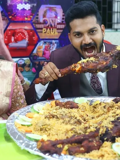 The groom takes a hearty bite from a roasted leg piece, part of a massive platter of biryani. We believe in generous portions and even more generous flavors.