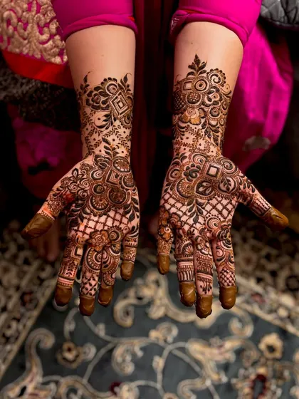Henna inspiration for a party or guest look. This design is intricate and detailed, covering the palm with a mix of geometric and floral patterns.