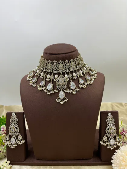 A close-up of the earrings from our all-white AD and pearl necklace set, highlighting the intricate craftsmanship.