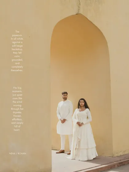 A classic portrait within a sandstone arch in Jaipur. The simplicity of the composition and the couple's coordinated white outfits create a serene and elegant pre-wedding photograph.