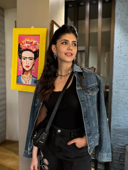 A front-facing view of the concert hairstyle. The hair is pulled away from the face in a simple half-up style, allowing her natural beauty to shine.