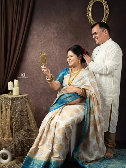 A sweet, candid moment during a traditional maternity shoot. The husband helps his wife with her hair, a small gesture of love and care that I love to capture.