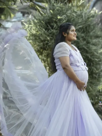 A light and airy lavender gown with a long, flowing train. This dress is perfect for capturing movement and creating an ethereal, romantic feel in your photos.
