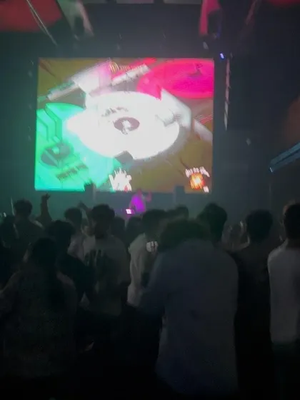Another view of the DJ booth and the large screen visuals at White Lotus Club.