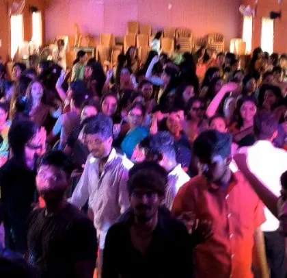Another view of the crowded college party, with everyone enjoying the music.