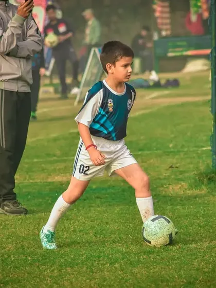 A young player looks for a pass while on the move.