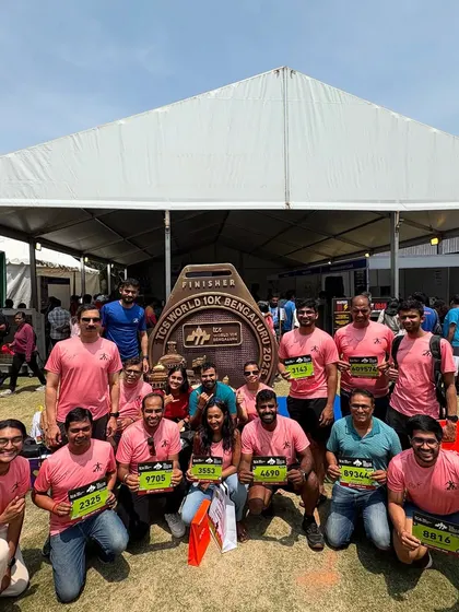 The team is all smiles at the TCS World 10K Bengaluru expo, picking up our race bibs and getting hyped for the big day.