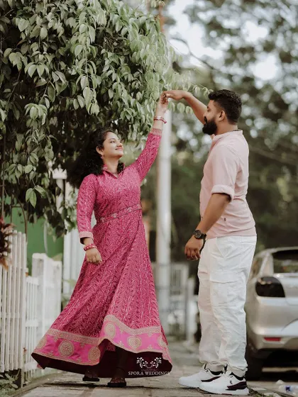 The couple sharing a dance on the sidewalk, a moment of spontaneous romance.