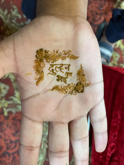 A traditional groom's mehndi design with the words 'Dulhan Bhai' (Bride's Brother) written in Hindi. It's a fun way to get into the festive spirit.