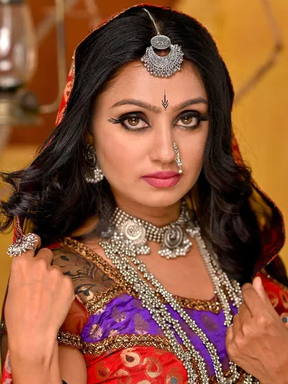 A close-up that captures the essence of the Rajasthani look. The focus is on the traditional makeup, with kohl-lined eyes, and the heavy silver jewellery.