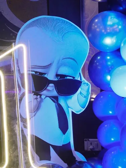 A close-up of the Boss Baby party decor, featuring a character cutout next to a neon '1' sign, perfect for a first birthday.