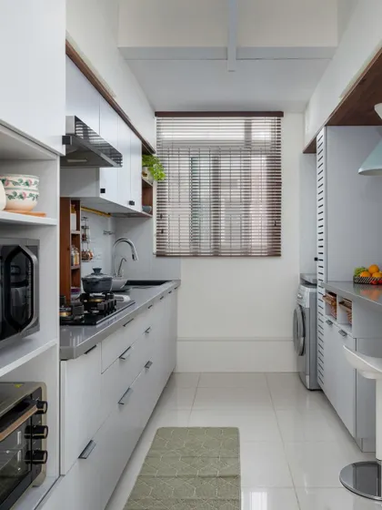 A full view of the parallel kitchen in 'Utopian Dreams,' designed for maximum efficiency and storage in a compact footprint.