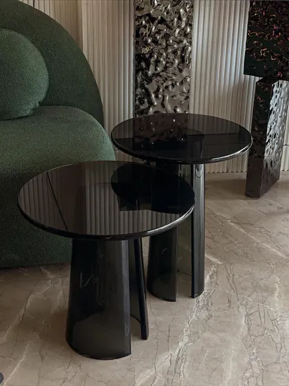 Another shot of the custom acrylic tables, showing how they interact with light and the surrounding decor. Their minimalist design allows them to blend in or stand out.