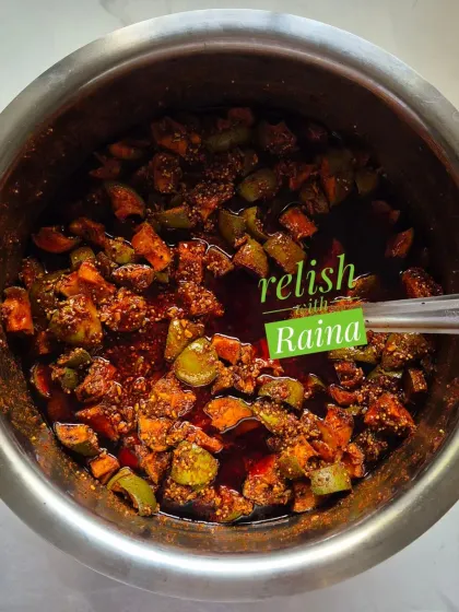 Here you can see my classic Spicy Khatti Kairi Pickle being prepared. I use Ladua kairi, a type of raw mango known for its sour taste and fleshy pulp, and mix it with my family's secret masala blend. This picture shows the pickle just after mixing, before it's left to mature and let the flavours deepen.