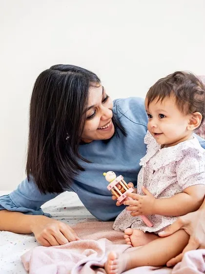 A sweet mother-daughter moment during a lifestyle session. I love capturing these natural cuddles and playtime scenes on the bed.
