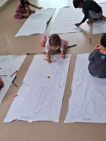 Children color and decorate their life-sized body outlines, personalizing their anatomy lesson.