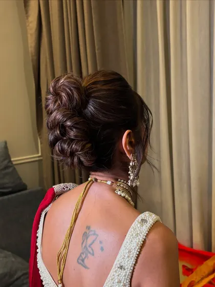 This image captures the volume and height of the stylish messy updo.