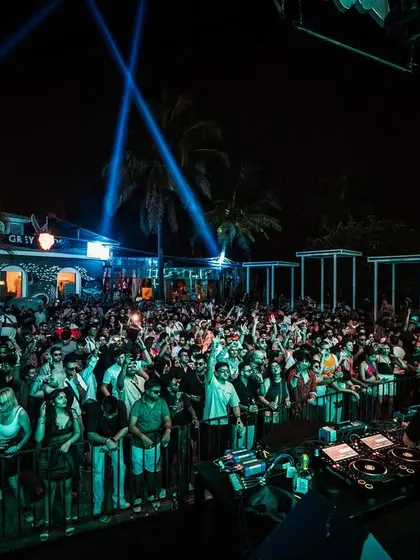 The view from our B2B set. A packed outdoor venue with palm trees and laser beams, the perfect setting for a powerful set.