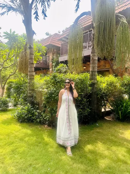This flowy white maxi dress is perfect for a warm day, keeping me cool and stylish.