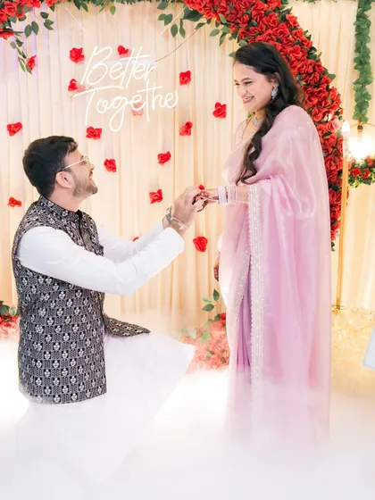 The moment it becomes official. We love capturing the ring exchange, especially with such a beautiful setup. The soft lighting and "Better Together" sign made this engagement ceremony feel magical.