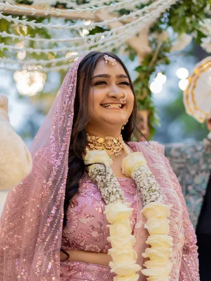 Pure joy captured. The natural, radiant makeup allows her happiness to shine through, creating a truly authentic and beautiful bridal moment.