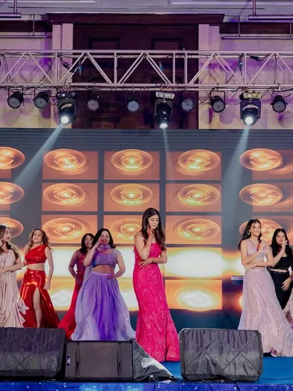 The entire bride squad on stage, ready to perform. The mix of colorful outfits and synchronized poses created a stunning visual.