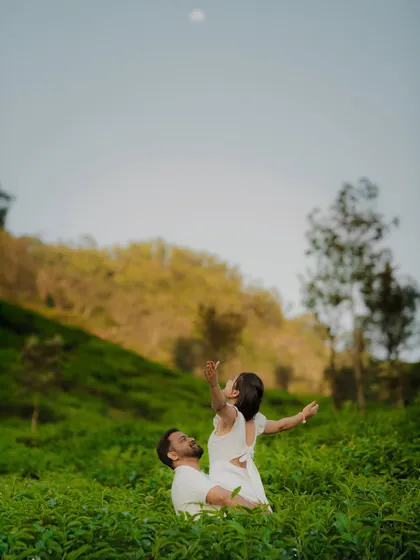 A wide-angle shot of a couple enjoying the open space of a tea plantation. This showcases the beautiful locations we can explore for your pre-wedding photoshoot.