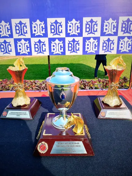 A collection of trophies for The Bangalore Juvenile Million, with the main trophy featuring a golden horse figurine.