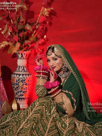 This shot captures the bride in her full green ensemble, with a hairstyle that is both elegant and strong enough to hold the traditional accessories.