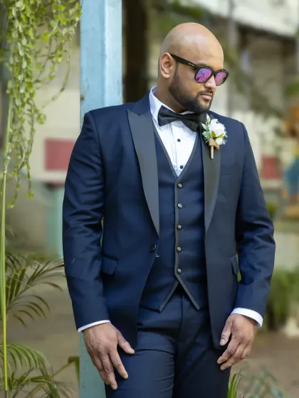 A stylish and modern groom portrait. The sunglasses and confident pose give this shot a cool, relaxed vibe.
