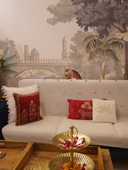 My sofa, styled for Diwali with festive cushions and a beautiful throw. Even the tiger on the wallpaper seems to be enjoying the celebration.