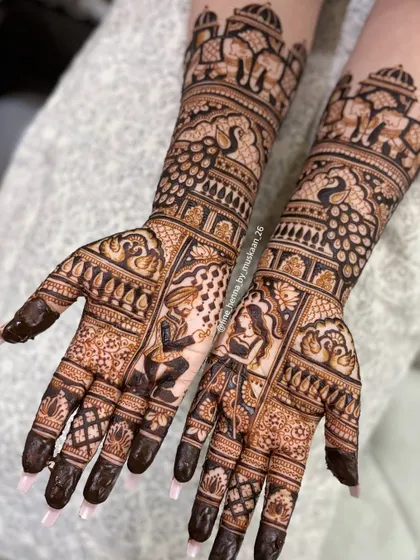 This is the kind of detailed work I love doing for engagements. This design features a full portrait of the couple, surrounded by intricate patterns, elephants, and peacocks, extending up the arm. It's a beautiful way to tell your story.