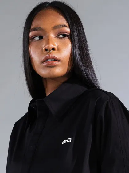 A close-up from a commercial fashion shoot, demonstrating a natural yet defined makeup look. The skin is perfected, and a soft liner enhances the eyes without overpowering the shot.