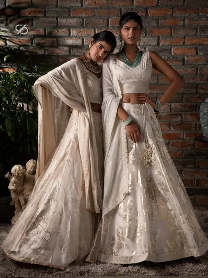 I believe in creating opportunities for you to express your distinct individuality. Here, two models showcase my white lehenga collection, featuring different styles in chanderi and organza.