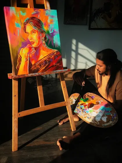 A quiet moment of reflection in the studio. I'm sitting with my palette next to a recently completed colorful portrait of Trintrin.