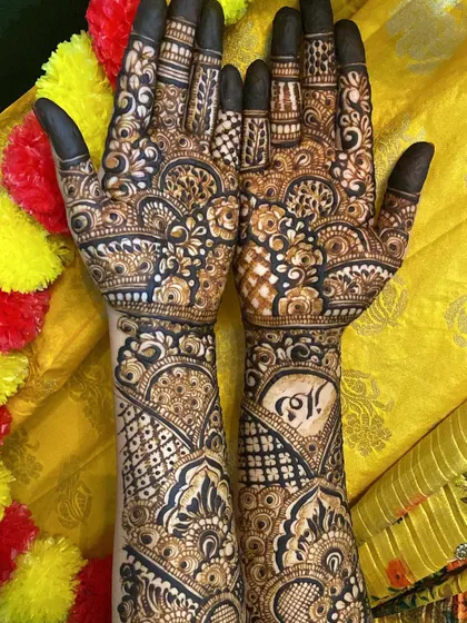 A full view of the bridal mehendi against a festive yellow background.