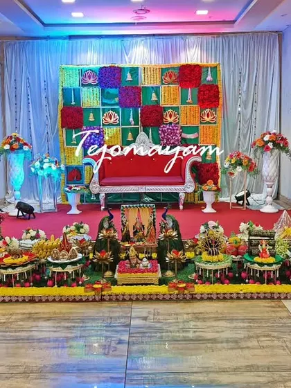 A wide view of a baby shower setup with a colorful checkerboard backdrop, showing how the decorations transform the entire space.