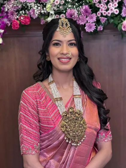 A radiant, smiling portrait that shows off her stunning antique pendant.