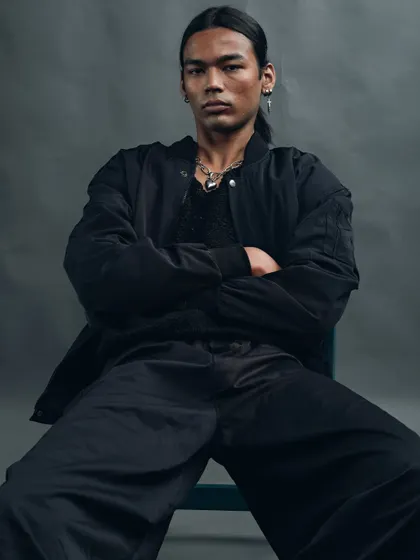 A variation of the seated portrait, showing a different angle and mood. The crossed arms and direct gaze convey strength and self-assurance, perfect for a model's portfolio.