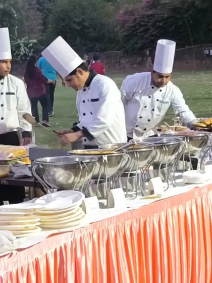 A closer look at our chefs preparing food for an outdoor buffet. Using fresh ingredients and professional equipment, we ensure every dish is cooked to perfection.