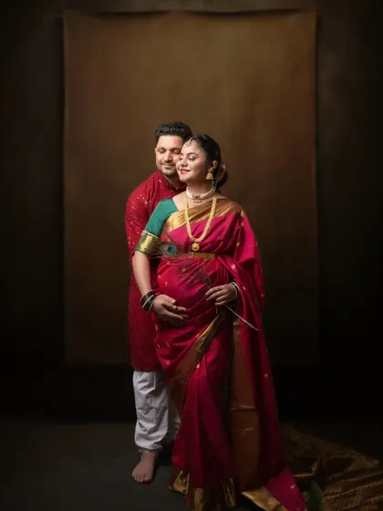 Wrapped in tradition and love, this couple eagerly awaits their little one's arrival in a portrait that is both vibrant and heartfelt.