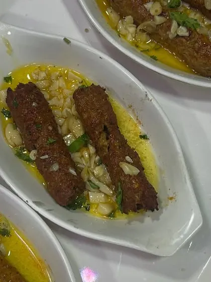 A photo of our Butter Garlic Seekh Kebab, paired with a delighted 5-star review. It's always a pleasure to see our food being enjoyed.