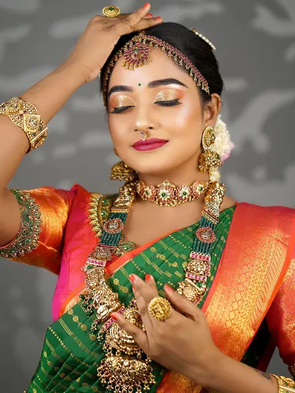 A graceful pose highlighting the flow of the saree and the beautiful hand accessories. The makeup remains flawless and radiant.